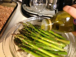 Spray pan and place asparagus in it. Add 3 tbs evoo (olive oil) and sprinkle salt on top.